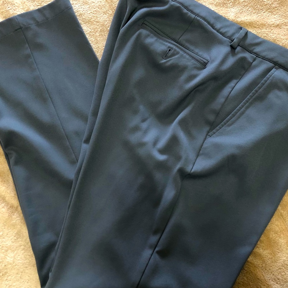 38/32 Greg Norman dress pants. Lightweight no wrinkle material in medium gray.